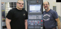 Tyler Zerbe (left), one of two students from R.G. Drage working at Quadra Tooling and Automation during his senior year, poses with Mike Alessandro, a Quadra employee who has helped to mentor him.